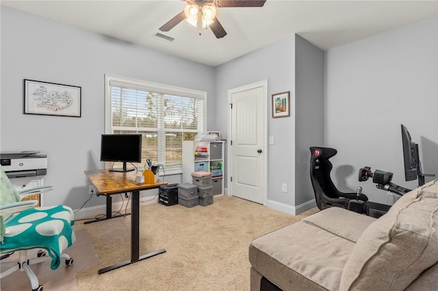 office space featuring ceiling fan and light carpet