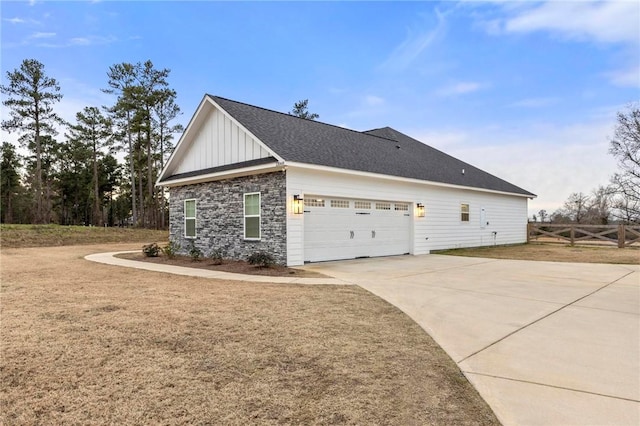 view of side of property with a lawn and a garage