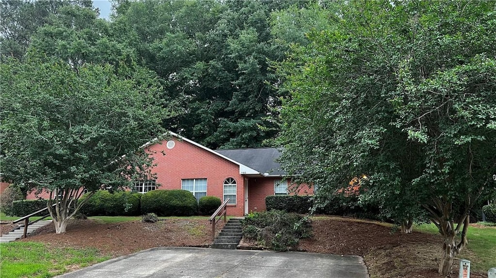 1181/1183 Northlake Dr, Auburn, AL 36830 - view of front of house with brick siding, stairway, and roof with shingles