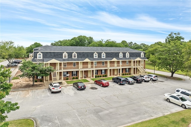1761 Wire Rd Unit 411, Auburn, AL 26832 - view of building exterior featuring stairway and uncovered parking