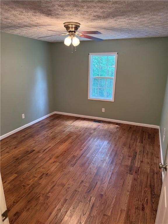 460 Waverly Rd, Auburn, AL 36832 - empty room with ceiling fan, wood finished floors, and a textured ceiling