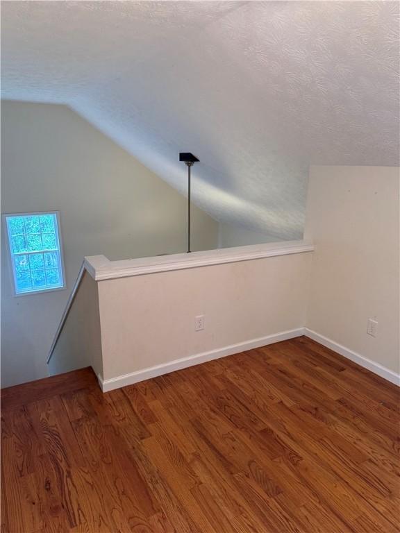 460 Waverly Rd, Auburn, AL 36832 - bonus room with vaulted ceiling, wood finished floors, and a textured ceiling