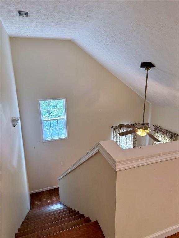 460 Waverly Rd, Auburn, AL 36832 - stairs featuring vaulted ceiling, a textured ceiling, ceiling fan, and wood finished floors