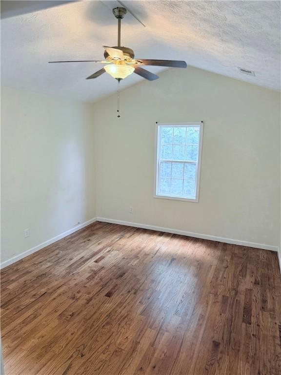 460 Waverly Rd, Auburn, AL 36832 - unfurnished room featuring wood finished floors, a ceiling fan, lofted ceiling, and a textured ceiling