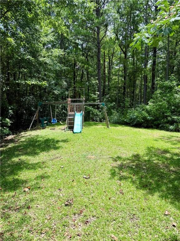 460 Waverly Rd, Auburn, AL 36832 - view of green lawn featuring a playground
