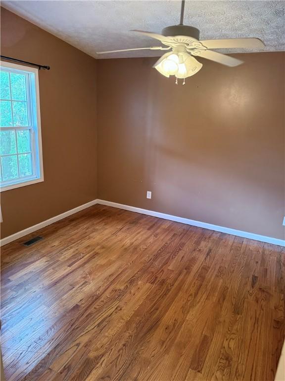 460 Waverly Rd, Auburn, AL 36832 - unfurnished room with wood finished floors, ceiling fan, and a textured ceiling