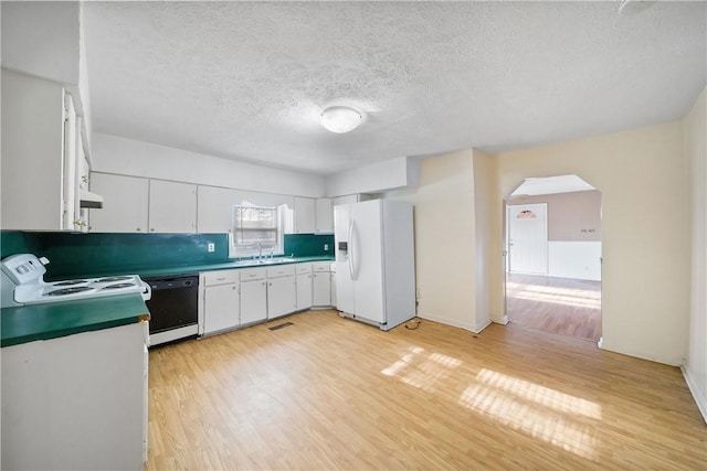 kitchen featuring white appliances, a textured ceiling, light wood-type flooring, white cabinetry, and sink