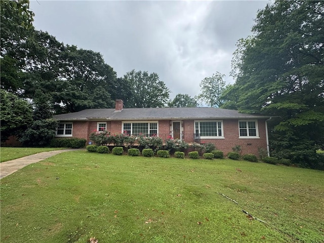 314 N 5th St, Opelika, AL 36801 - ranch-style house featuring brick siding, a front lawn, and a chimney