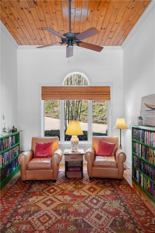 living room featuring light hardwood / wood-style floors, a wealth of natural light, ornate columns, and wooden ceiling