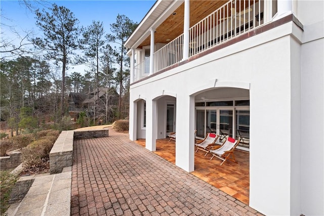 view of patio featuring a balcony