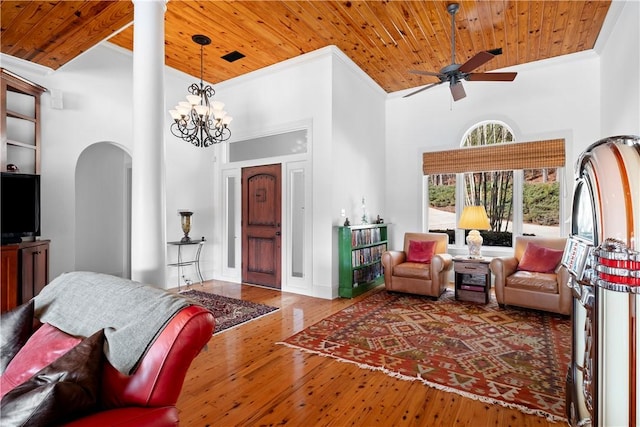 living room featuring wood ceiling, wood-type flooring, and a towering ceiling