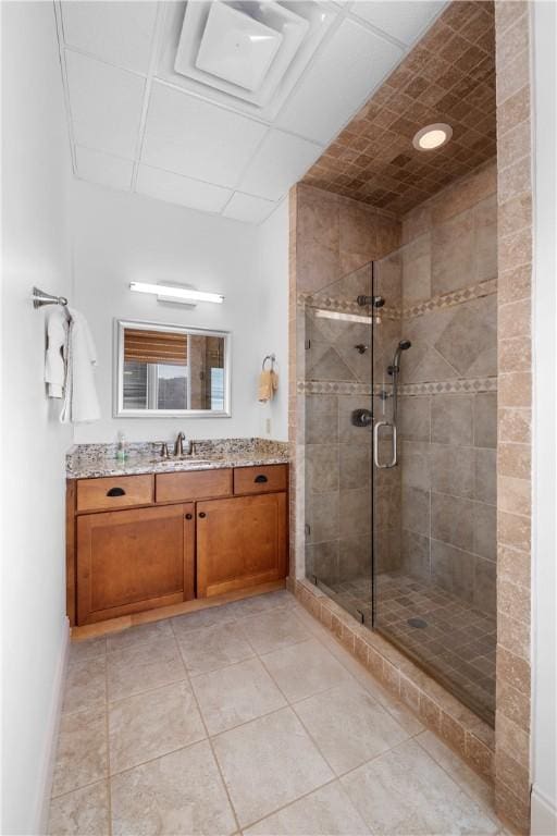 bathroom featuring vanity, tile patterned floors, and a shower with shower door