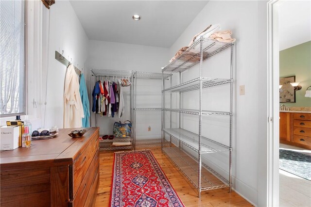 bathroom featuring tile patterned floors, a shower with door, and vanity