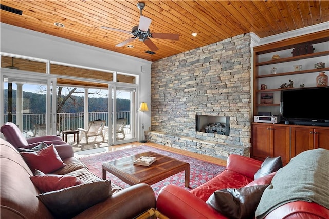 living room featuring wood-type flooring, wood ceiling, a fireplace, and ceiling fan