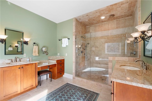 bathroom with tile patterned floors, a shower with door, and vanity