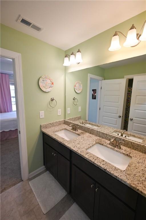 261 Woodward Way, Auburn, AL 36832 - bathroom with double vanity and baseboards