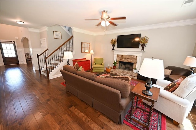 261 Woodward Way, Auburn, AL 36832 - living room with stairway, a fireplace, ceiling fan, arched walkways, and hardwood / wood-style flooring