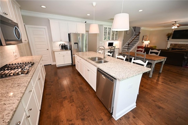 261 Woodward Way, Auburn, AL 36832 - kitchen featuring stainless steel appliances, a sink, a fireplace, open floor plan, and ornamental molding