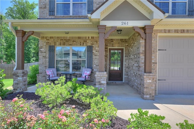 261 Woodward Way, Auburn, AL 36832 - entrance to property featuring covered porch, brick siding, and a garage