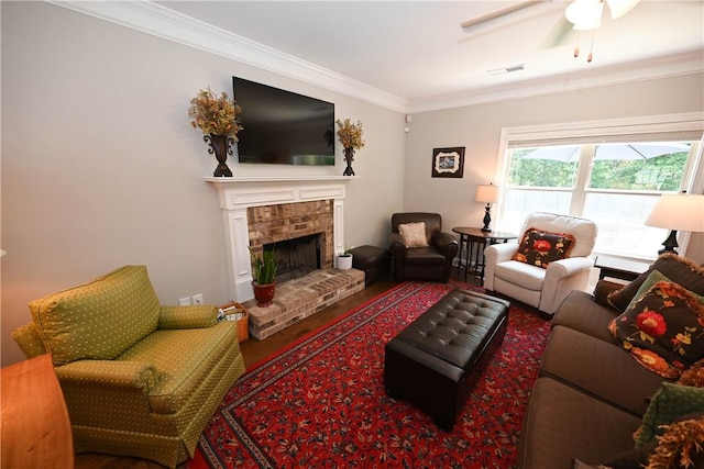 261 Woodward Way, Auburn, AL 36832 - living room featuring crown molding, ceiling fan, a fireplace, and wood finished floors