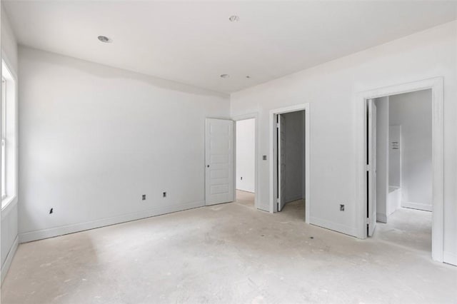 208 Byrd Ave, Opelika, AL 36801 - unfurnished bedroom with a walk in closet, multiple windows, and baseboards