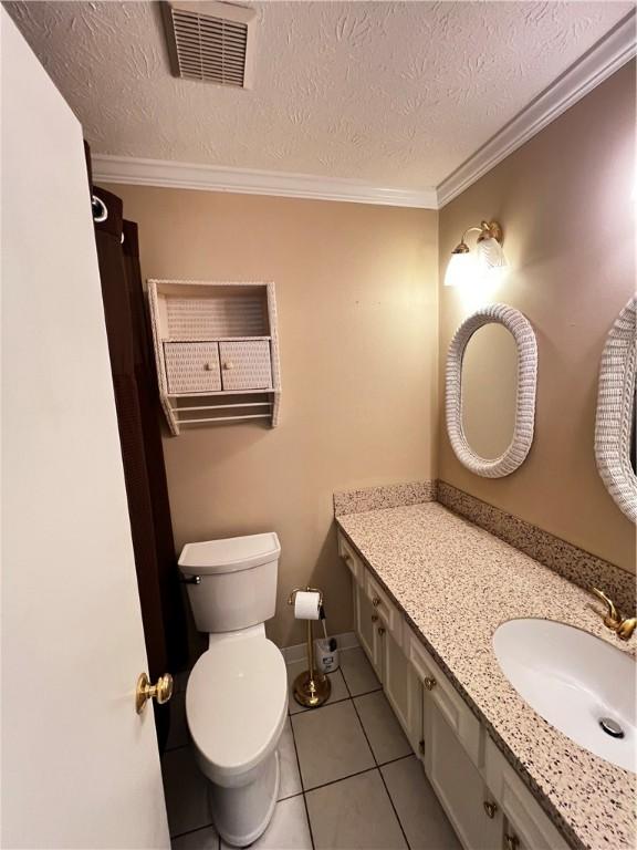 1128 Overwood Pl, Auburn, AL 36830 - bathroom featuring vanity, tile patterned flooring, ornamental molding, and a textured ceiling