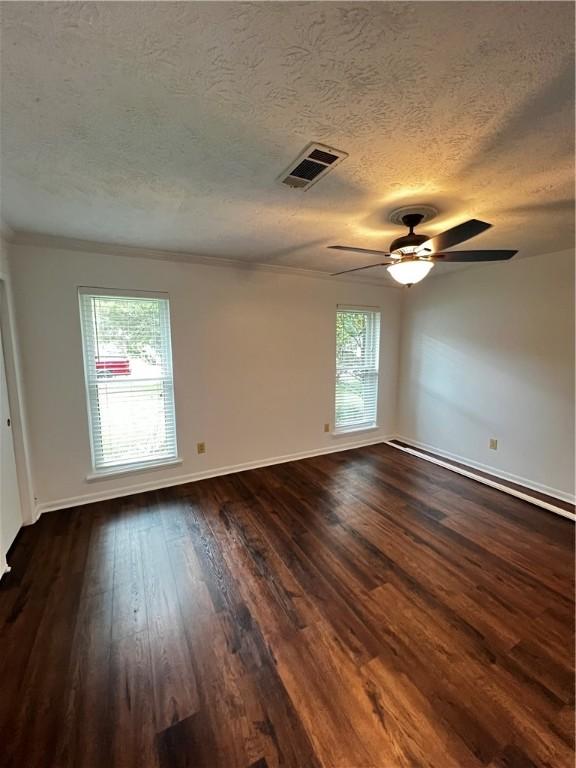 1128 Overwood Pl, Auburn, AL 36830 - unfurnished room with a textured ceiling, dark wood-style flooring, a ceiling fan, and ornamental molding