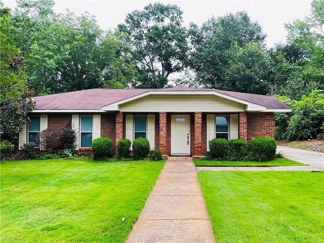 1128 Overwood Pl, Auburn, AL 36830 - view of front of home with brick siding, a front lawn, and a porch
