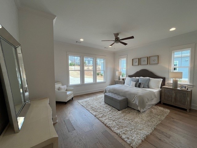 bedroom with ceiling fan and wood-type flooring