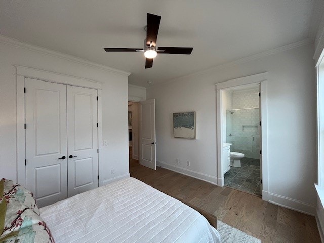 bedroom with ornamental molding, dark hardwood / wood-style floors, ensuite bathroom, and a closet