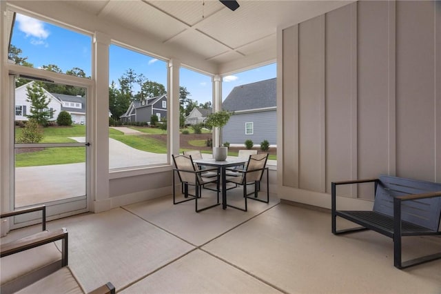 sunroom / solarium featuring ceiling fan