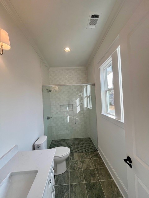 bathroom featuring crown molding, tiled shower, vanity, and toilet