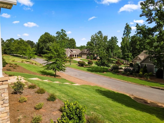 view of property's community with a lawn