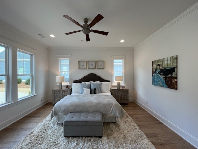 bedroom with crown molding, ceiling fan, and dark hardwood / wood-style flooring