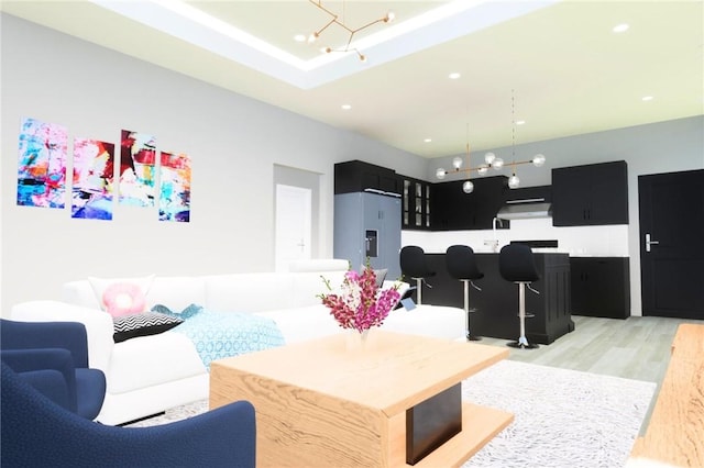 living room featuring an inviting chandelier and light hardwood / wood-style flooring