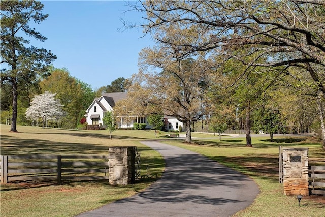 view of community with a yard and fence