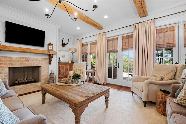 living area featuring light wood-style floors, french doors, a brick fireplace, and beam ceiling