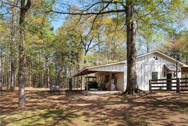 view of yard with an outbuilding, a pole building, and an attached carport