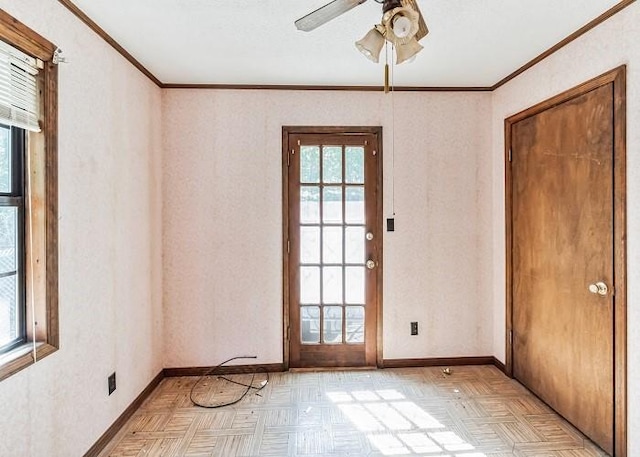 spare room with ceiling fan, crown molding, and light parquet flooring