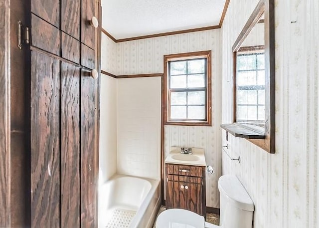 bathroom with a textured ceiling, vanity, a tub to relax in, and toilet