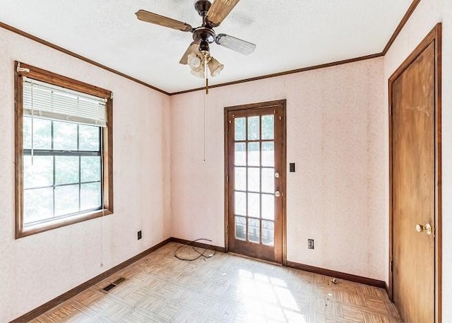 spare room with light parquet floors, ceiling fan, and crown molding