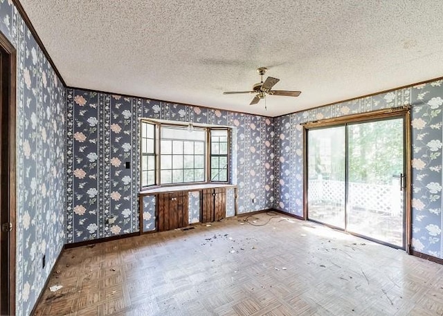 spare room featuring ceiling fan, a textured ceiling, and parquet flooring