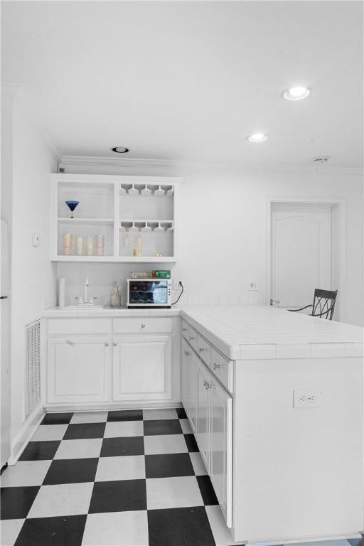 1540 Lakewood Pl, Auburn, AL 36801 - kitchen with white cabinetry, open shelves, tile patterned floors, a sink, and a peninsula