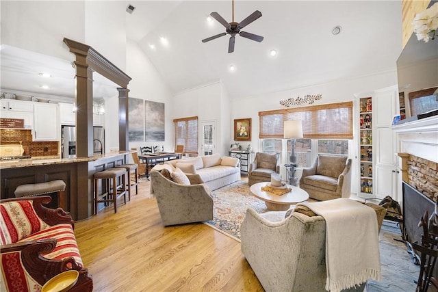 1540 Lakewood Pl, Auburn, AL 36801 - living area featuring high vaulted ceiling, visible vents, ceiling fan, a stone fireplace, and light wood-style floors