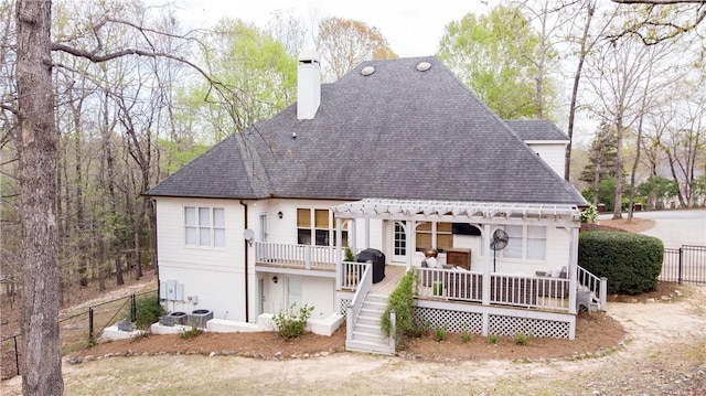 1540 Lakewood Pl, Auburn, AL 36801 - rear view of house featuring a pergola, a chimney, a shingled roof, and fence