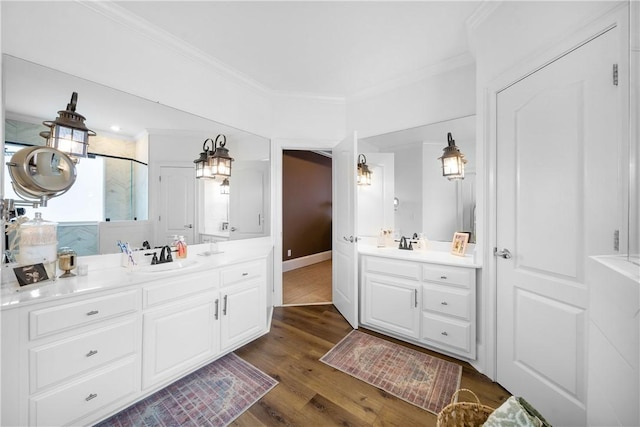 1540 Lakewood Pl, Auburn, AL 36801 - bathroom featuring a sink, wood finished floors, ornamental molding, and two vanities