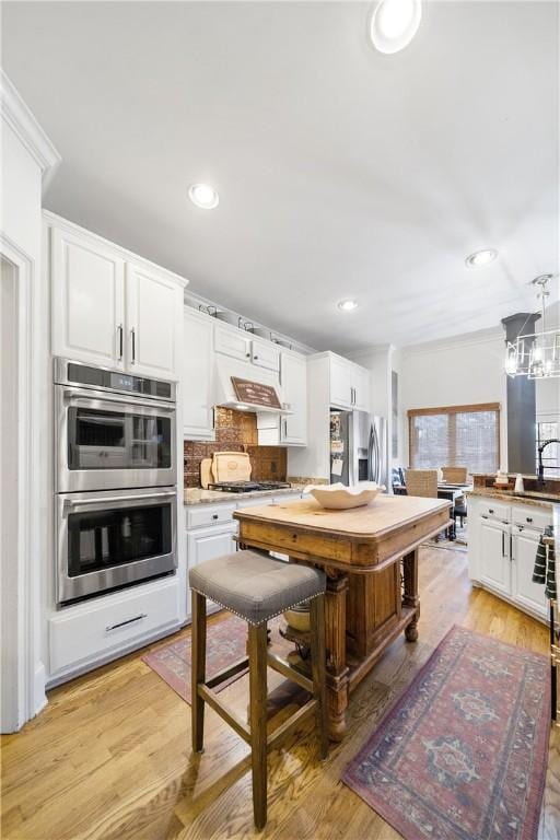 1540 Lakewood Pl, Auburn, AL 36801 - kitchen featuring white cabinetry, stainless steel appliances, and under cabinet range hood