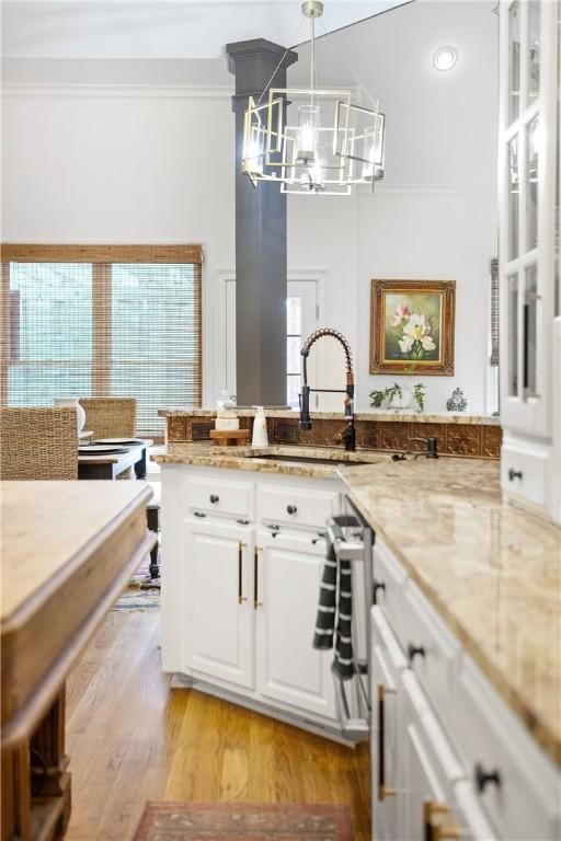 1540 Lakewood Pl, Auburn, AL 36801 - kitchen with a sink, a chandelier, white cabinetry, light wood-type flooring, and ornamental molding