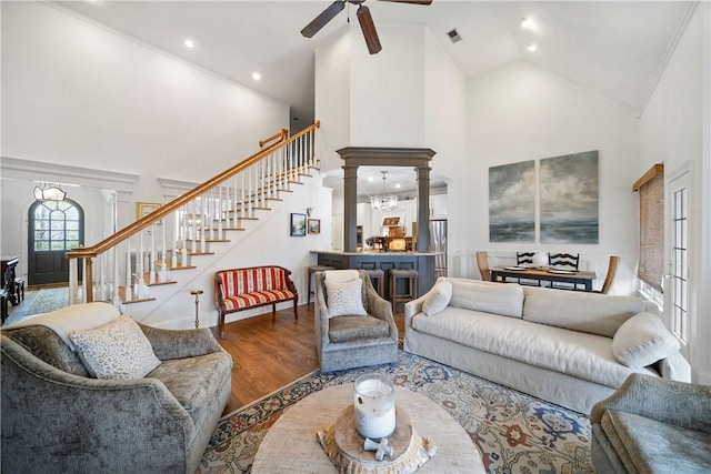 1540 Lakewood Pl, Auburn, AL 36801 - living room featuring decorative columns, high vaulted ceiling, stairway, and wood finished floors