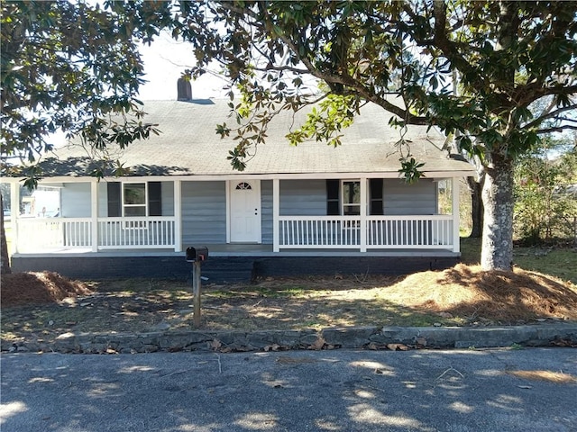 new england style home featuring covered porch